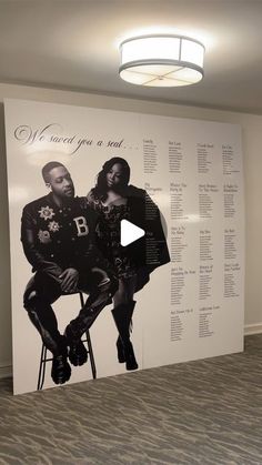 a large wall mural with two black men sitting on top of each other in an office