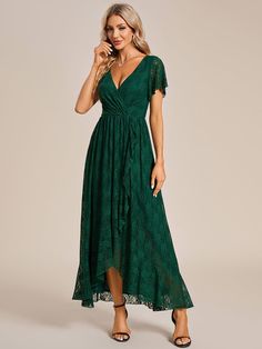 a woman wearing a green lace dress