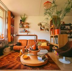 a living room filled with lots of furniture and plants on top of the tables in front of them