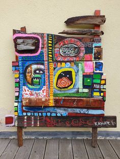 a bench made out of different colored pieces of art