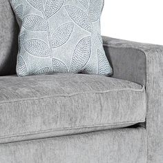 a gray couch with a blue and white pillow on it's backrests