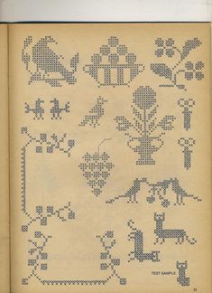 an old book with cross stitch designs on it