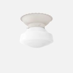 a white ceiling light with a scalloped shell on the top and bottom part