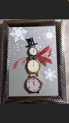 a snowman made out of clocks sitting on top of a silver tray with red and white decorations