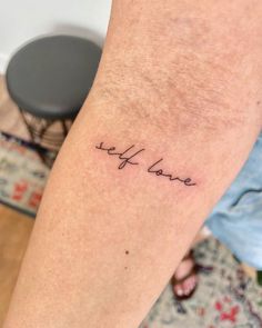 a person with a tattoo on their arm that says, let love be loved in cursive writing