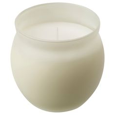 a white candle sitting inside of a glass vase