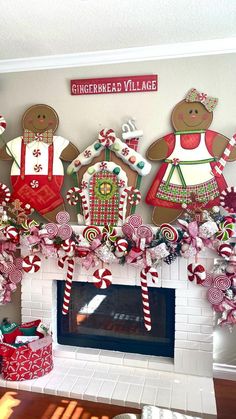 a fireplace decorated for christmas with gingerbread village decorations and candy canes on the mantel