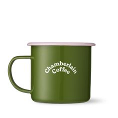 a green enamel mug with the words,'cramberian coffee'printed on it