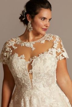 a woman in a wedding dress with an open back and sheer lace on the top