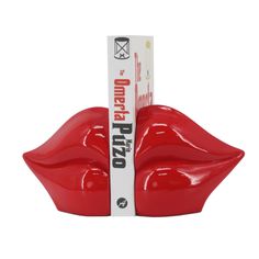 a red lip shaped container with a white stick sticking out of it