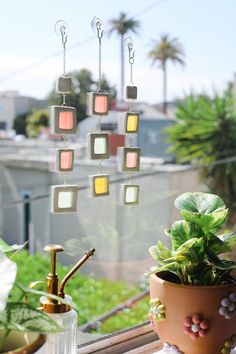 a potted plant sitting on top of a window sill next to a lamp