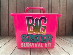 the big sister survival kit is pink and has graffiti on it, as well as letters