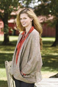 a woman standing next to a wooden bench