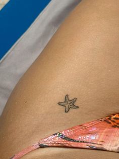 a woman with a starfish tattoo on her stomach