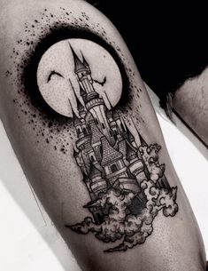 a man's leg with a castle tattoo on it