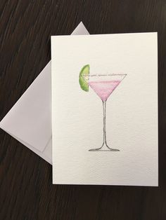 a card with a watercolor drawing of a martini glass and a slice of lime