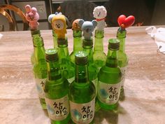 there are many green bottles with small animals on them in the shape of teddy bears