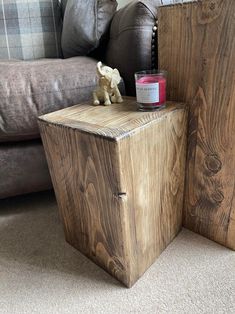 a wooden box sitting on the floor next to a couch