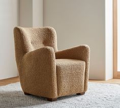 a brown chair sitting on top of a white rug