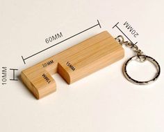 a wooden keychain with two pieces of wood attached to it and measurements for each piece