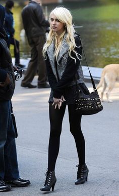 a woman in tights and boots standing next to a man