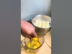 a person is mixing some food in a blender on a table with other ingredients