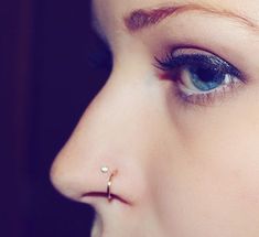 a woman's nose has a piercing on it