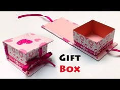 two boxes with pink and white designs on them, one has a ribbon tied around it