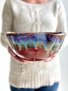 a woman holding a colorful bowl in her hands