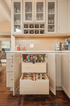 an open cabinet in the middle of a kitchen