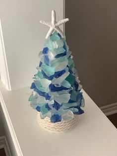 I make each sea glass tree from scratch. They are all unique pieces. I have many variations in green, blue, and white in various shades. With the starfish each tree is approx 9 inches and without it 7.5 inches. If you are purchasing this particular product the mix of sea glass will be in green, blue and white. This is a made to order product, and not the exact one in the photos. I will send a photo of the tree to the buyer before I send for final approval. Each tree is fairly heavy but buil