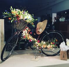 a bicycle decorated with flowers is on display