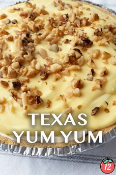 there is a pie with white frosting and walnuts on the top that says texas yum yum