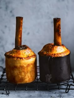 there are two pots that have some food in them on the rack and one is made out of bread