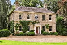 a large brick house with ivy growing on it's sides