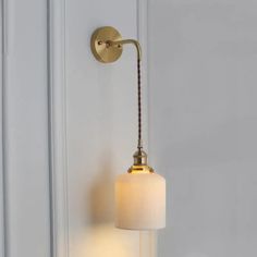 a wall light that is on the side of a door with a cord attached to it