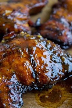 grilled chicken wings on a cutting board covered in bbq sauce