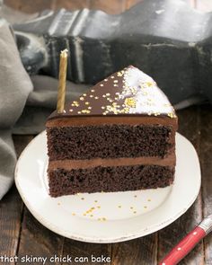 a slice of chocolate cake with gold sprinkles