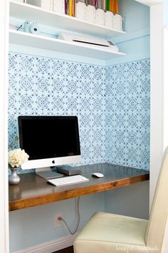 a desk with a computer on it and a chair in front of the monitor screen