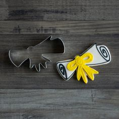 two cookie cutters sitting next to each other on top of a wooden table,