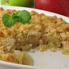 a close up of a plate of food with an apple in the background