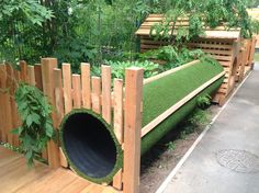 a wooden bench made out of grass with a hole in the middle that has been dug into it