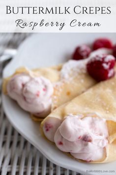 two crepes on a plate with raspberry cream