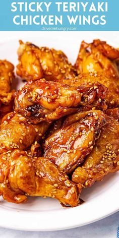 chicken wings on a white plate with sesame seeds