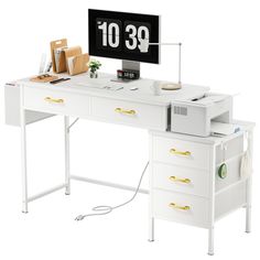 a white desk with a computer on it and an office clock above the top shelf