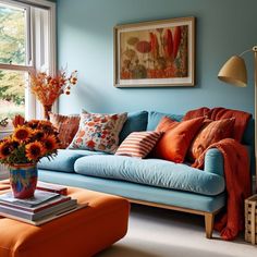 a living room filled with furniture and colorful pillows on top of it's blue couch