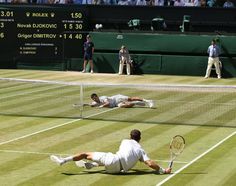 two tennis players are playing on the court with rackets in their hands as people watch