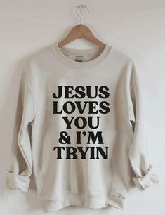 Jesus Loves You i'm Tryin Christian Sweatshirt, Bible Verse Sweatshirt, Aesthetic Christian Sweatshirts, Jesus Sweatshirt, Church Sweatshirt Welcome to Bee Design Gifts If you are looking for soft, comfy, first-rate sweatshirts, you're in the right place! I love what I do and strive to make your shopping experience just right for you. If you have any questions, concerns or comments about my products, feel free to send a message anytime. ⭐ 50% cotton, 50% polyester ⭐ Pre-shrunk ⭐Classic fit ⭐ 1x1 athletic rib knit collar with spandex ⭐ Air-jet spun yarn with a soft feel and reduced pilling ⭐Double-needle stitched collar, shoulders, armholes, cuffs, and hem HOW TO PLACE ORDER 1. Check photos for size chart, model comparison and color options 2. Select size and color from the drop down option Christian Sweatshirts, Aesthetic Christian, Jesus Sweatshirts, Sweatshirt Aesthetic, Jesus Love, Retro Sweatshirts, Cute Shirt Designs, Christian Sweatshirt, Letter Print Sweatshirt