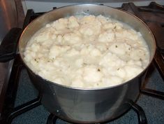 a pot filled with food sitting on top of a stove