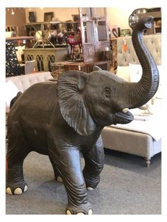 an elephant statue is shown in front of a couch